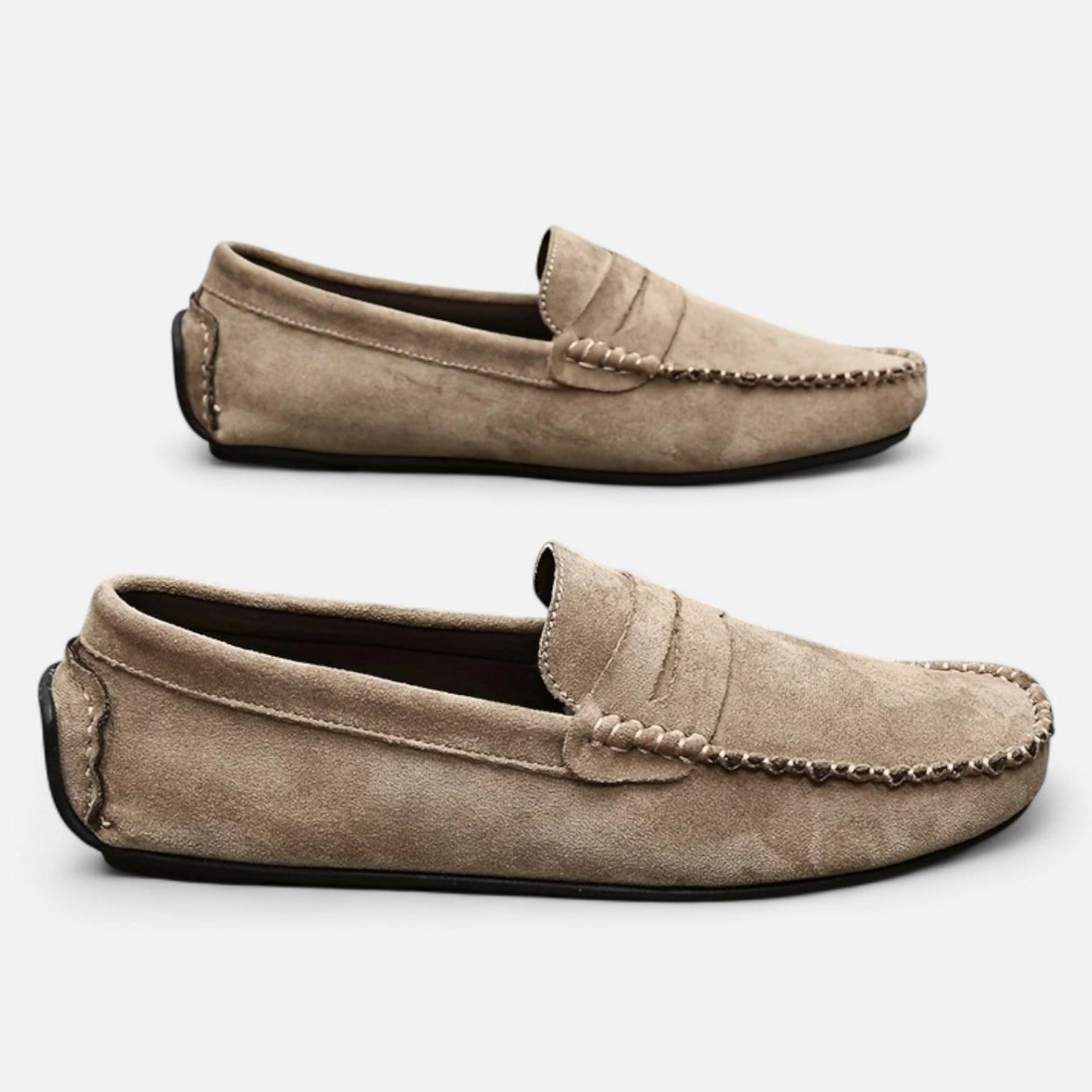 Beige taupe suede moccasin loafers with saddle strap and contrast stitching, paired overhead view displaying hand-sewn apron construction and flexible rubber outsole