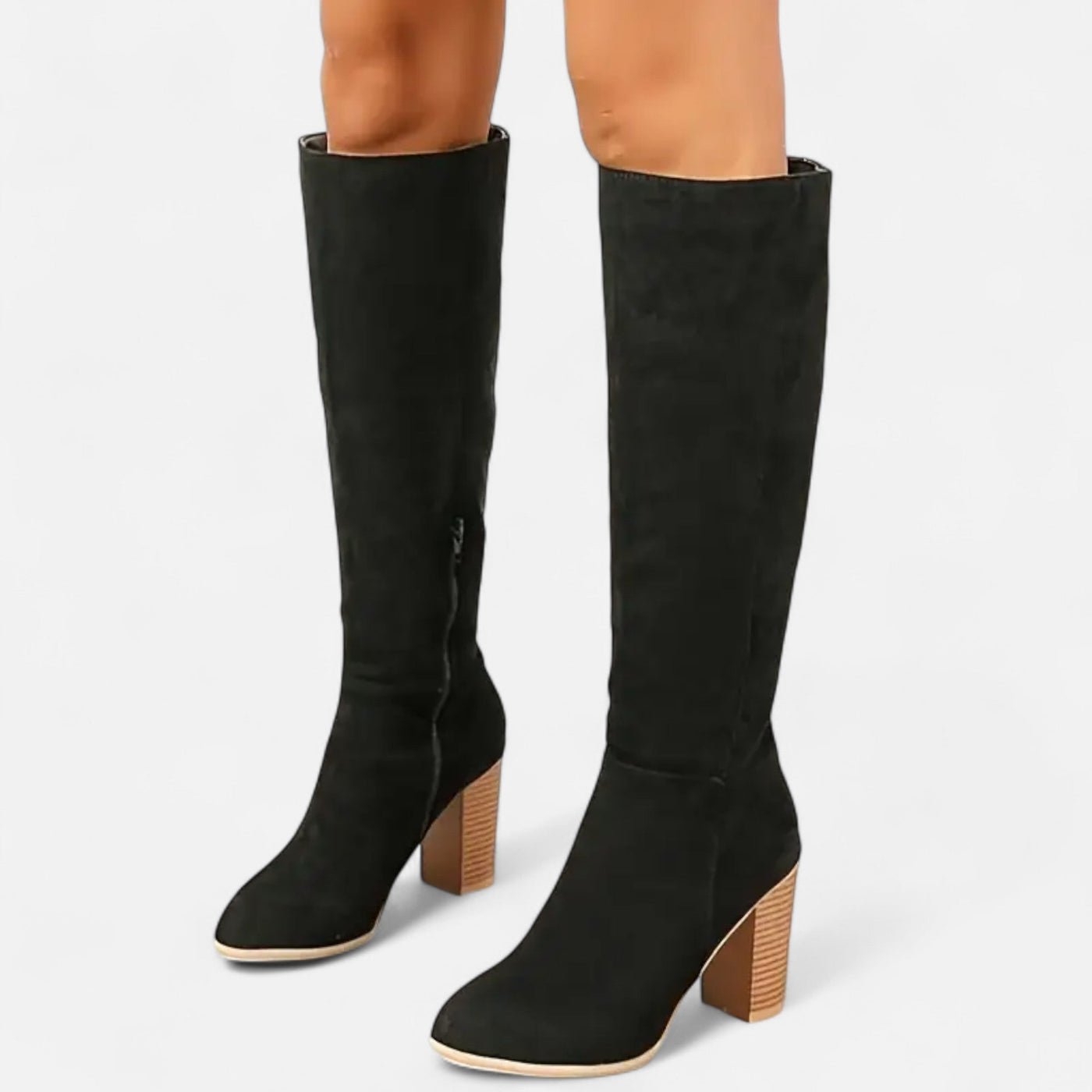 Black suede knee-high boots with stacked wood-effect block heel and side zip closure, front on-model view showing round toe and shaft construction