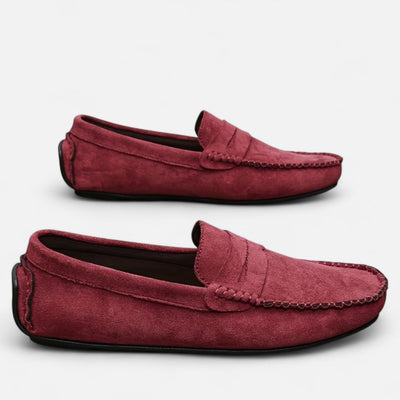 Burgundy red suede slip-on loafers with tonal penny keeper and hand-stitched seam details, dual angle view featuring textured suede finish and black rubber driving sole