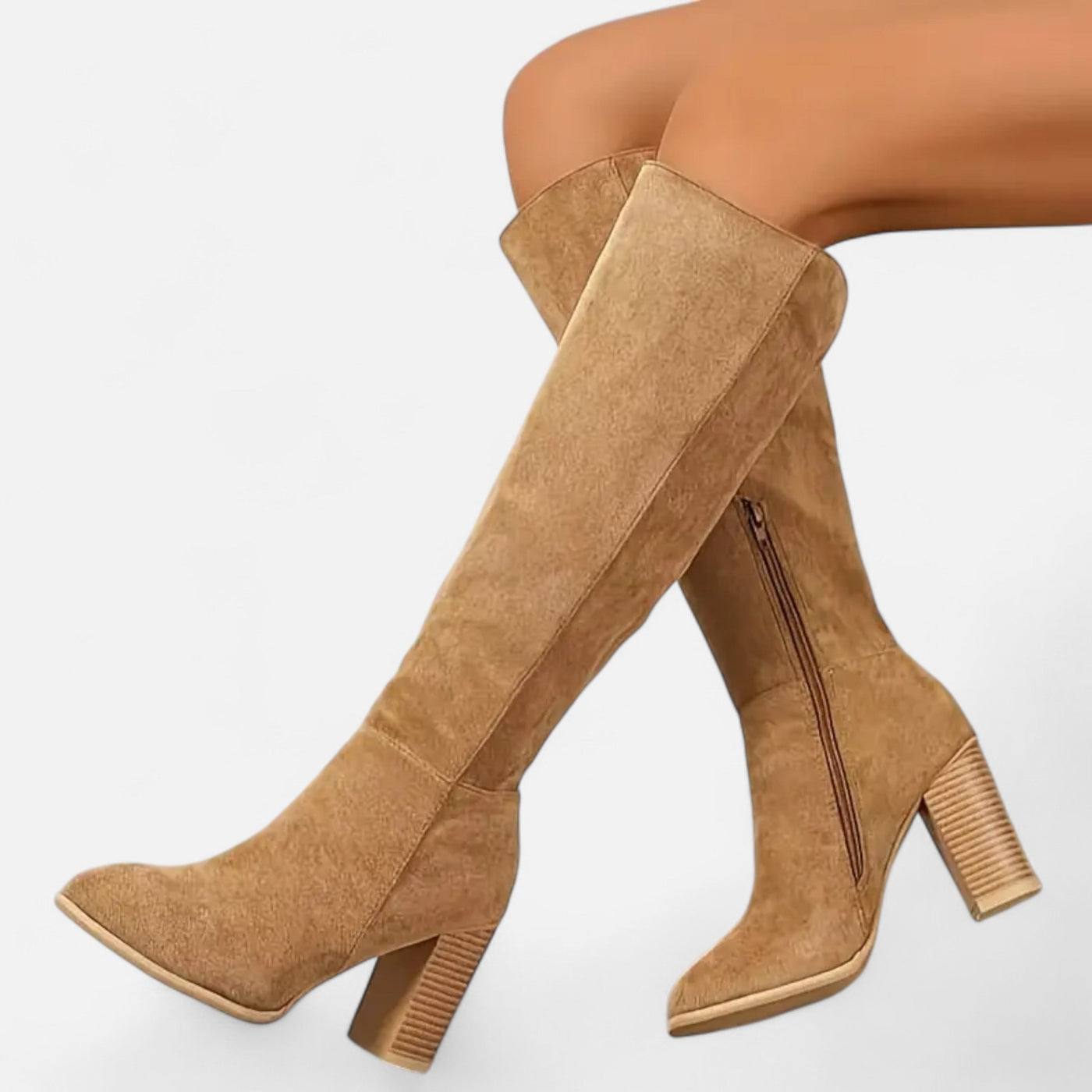 Camel beige suede tall boots with chunky grooved block heel and pointed toe, on-model side angle showing knee-length shaft and interior side zipper detail