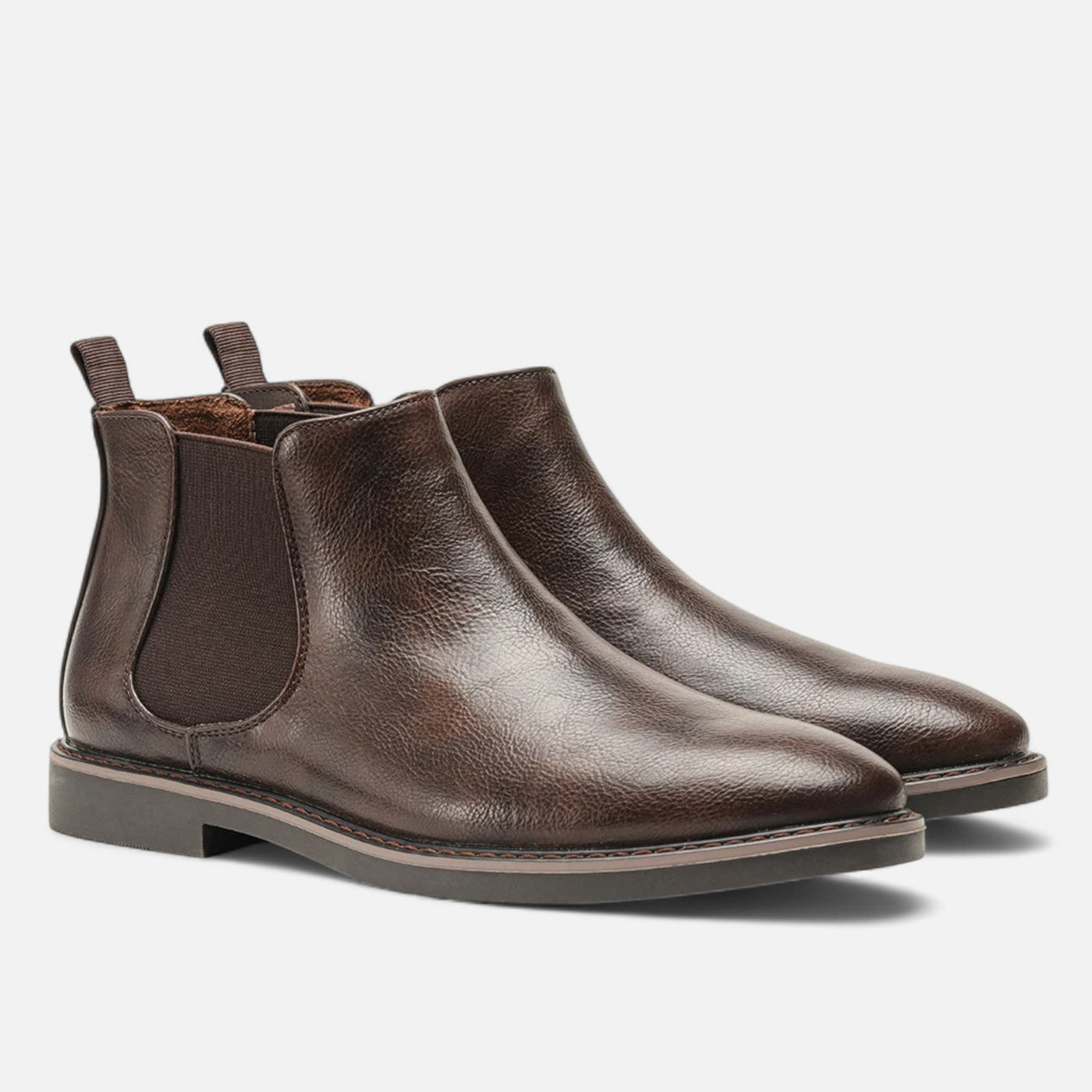 Dark brown leather Chelsea ankle boots with tonal elastic panels and fabric pull loops, paired perspective displaying grain leather finish and low block heel construction