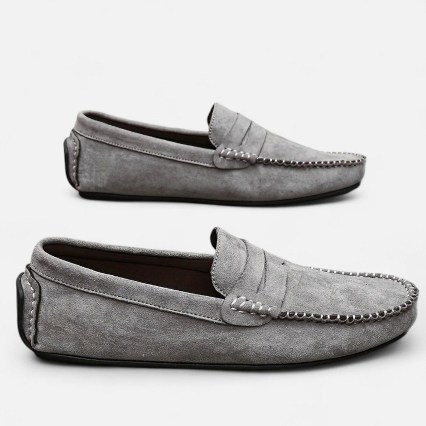 Grey suede casual driving shoes with saddle vamp and moc-toe stitching detail, paired display showing soft suede texture and flexible black rubber bottom unit