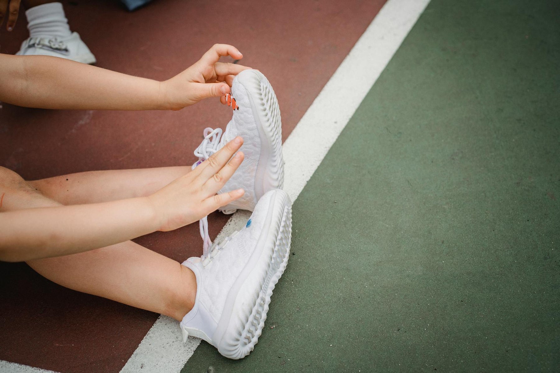 white sneakers on a playground worn by a model