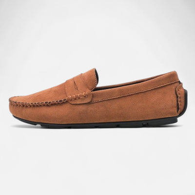 Tan brown suede driving loafer with hand-stitched moccasin construction and penny strap detail, side profile view showing rubber pebble sole and tonal topstitching