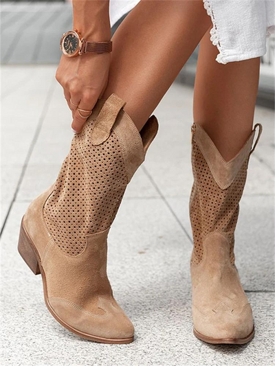 Tan camel cowgirl boots with breathable circular cutout perforations throughout shaft and chunky wooden heel, on-model paired front view displaying pointed western toe shape and pull loop detail