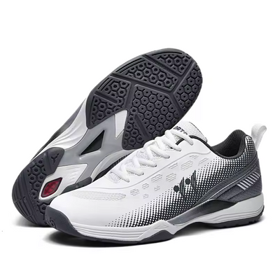 White athletic trainer with black checkered gradient pattern and grey accents, combination view featuring charcoal rubber outsole with geometric traction pod design and reinforced toe cap